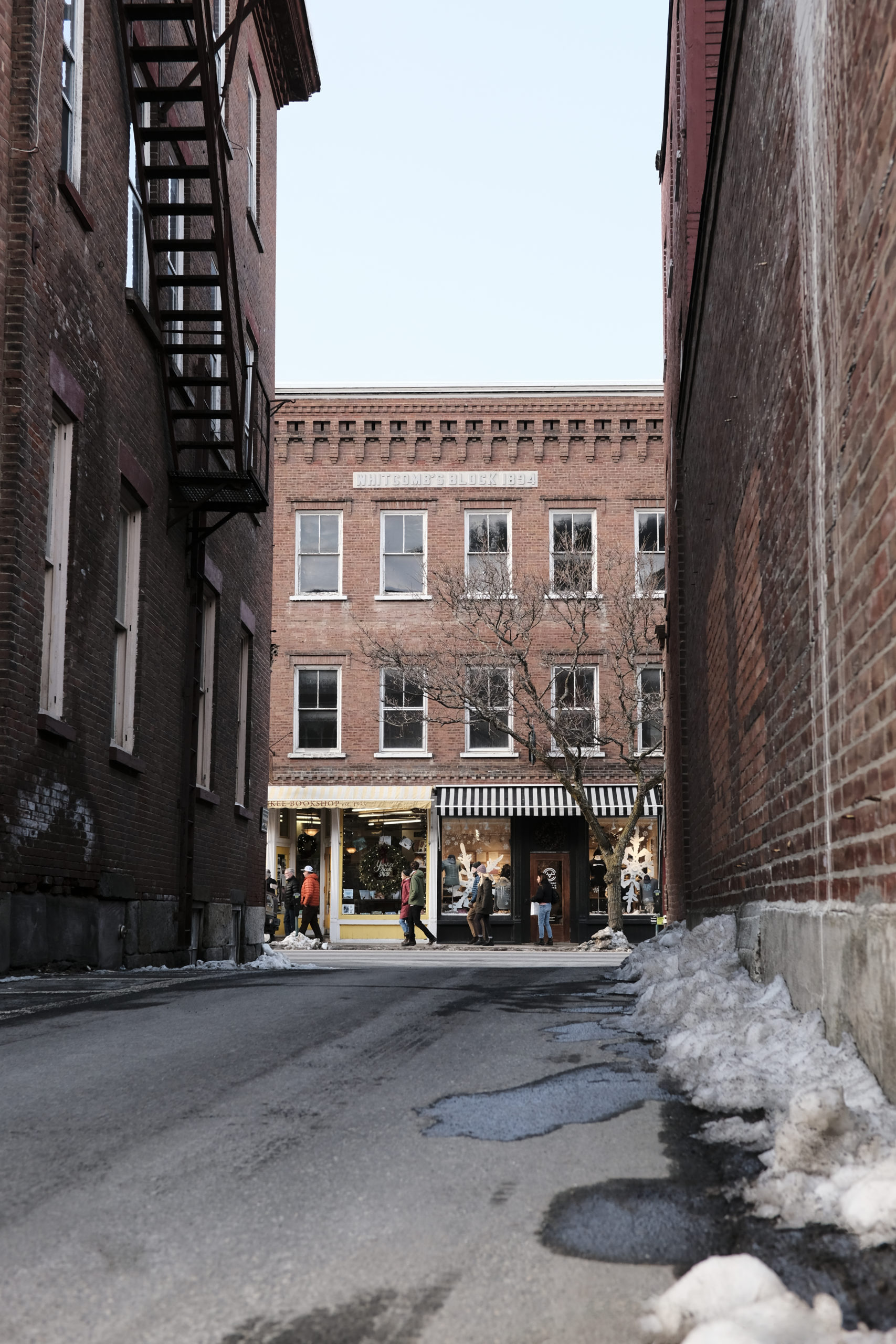 An alleyway with tourists shopping at Whitcomb's Block